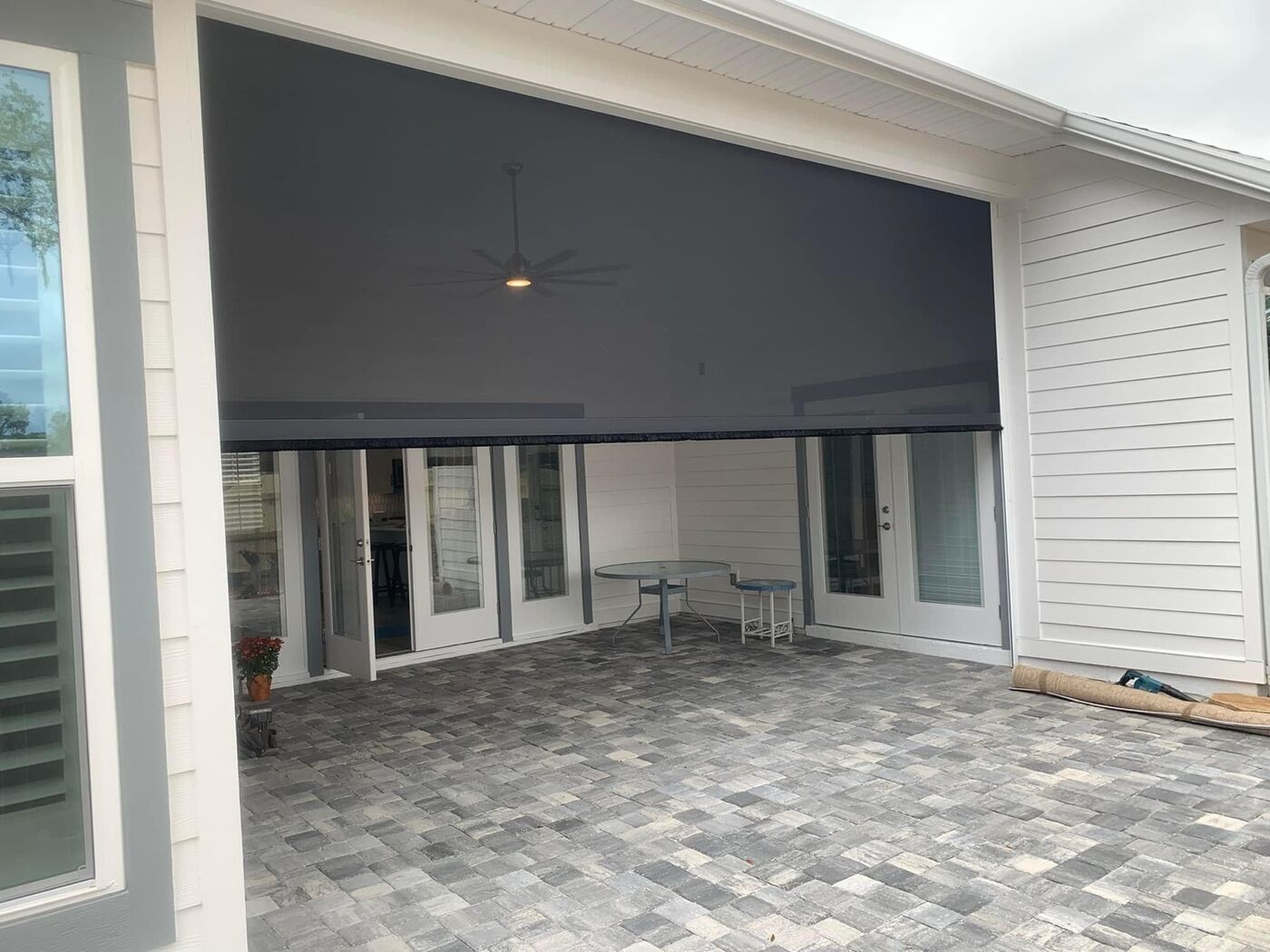 Motorized retractable screens on a covered patio