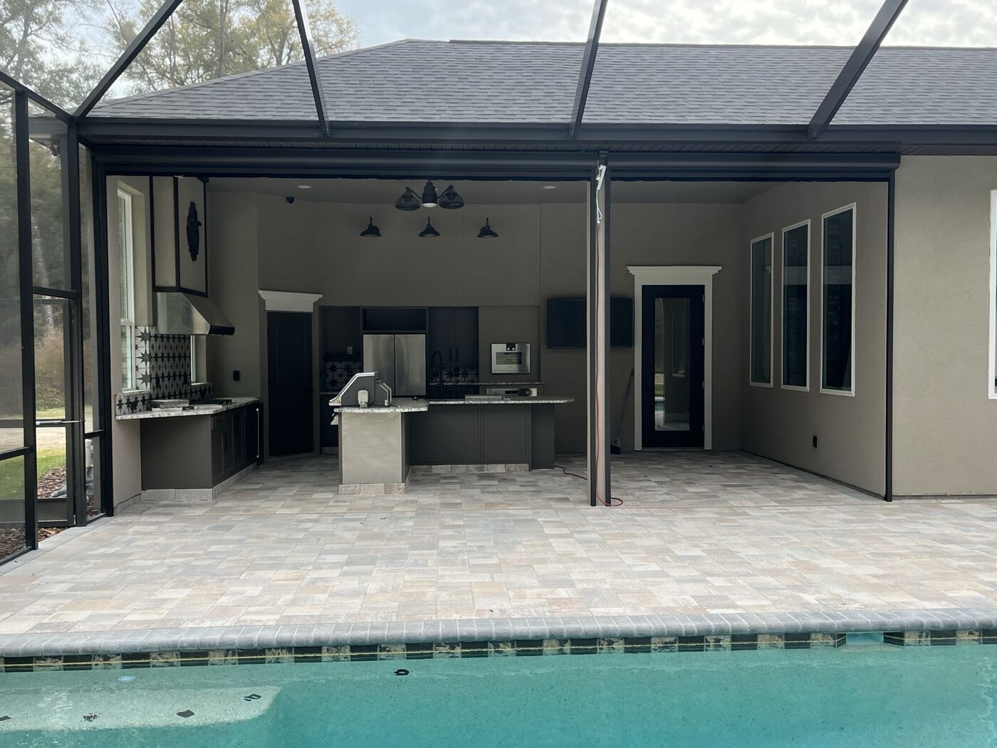 Screened pool cage with outdoor kitchen