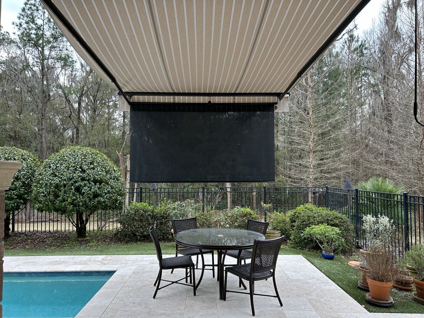 Retractable awning over a poolside patio