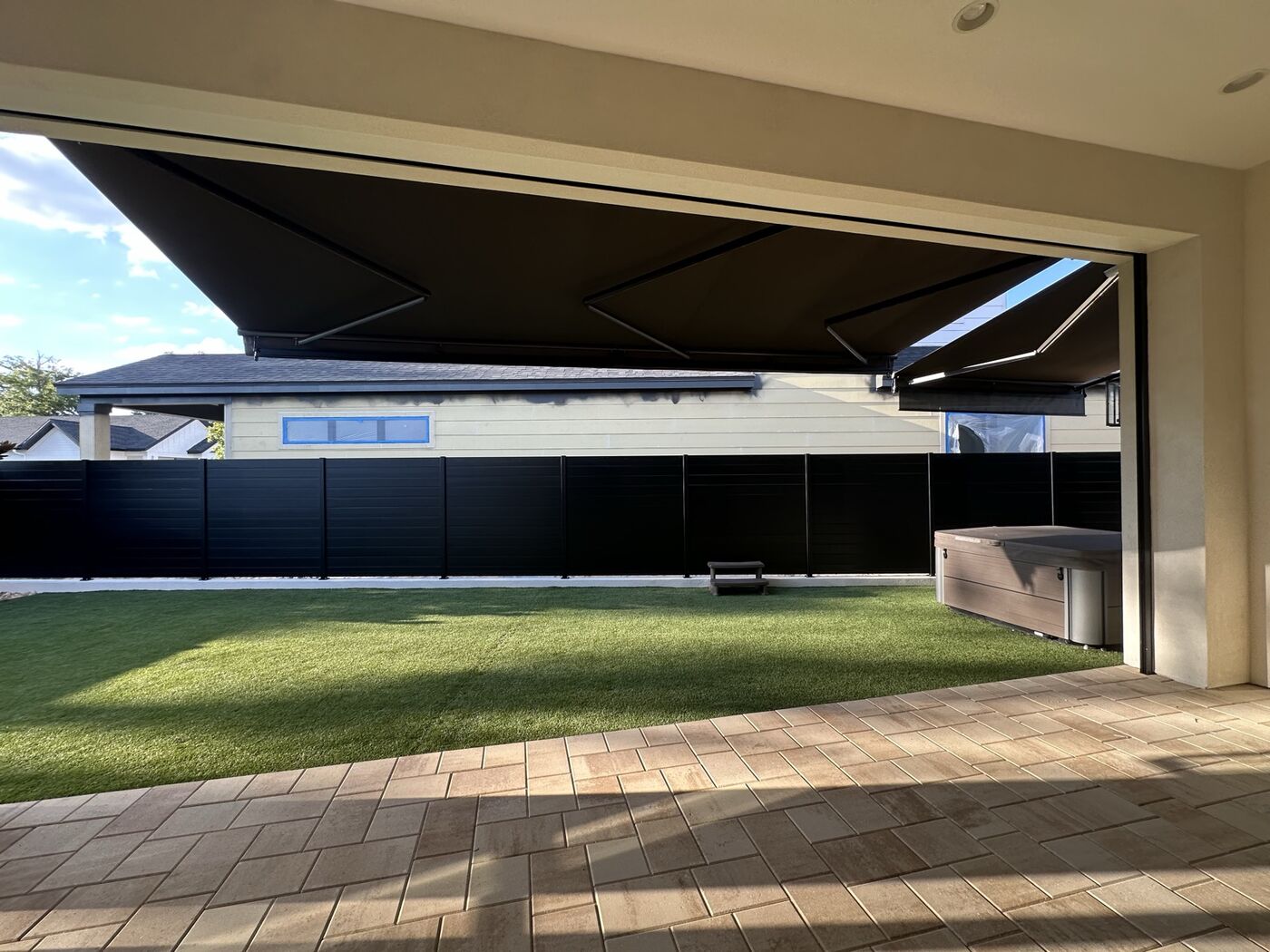 Retractable awning over a backyard patio