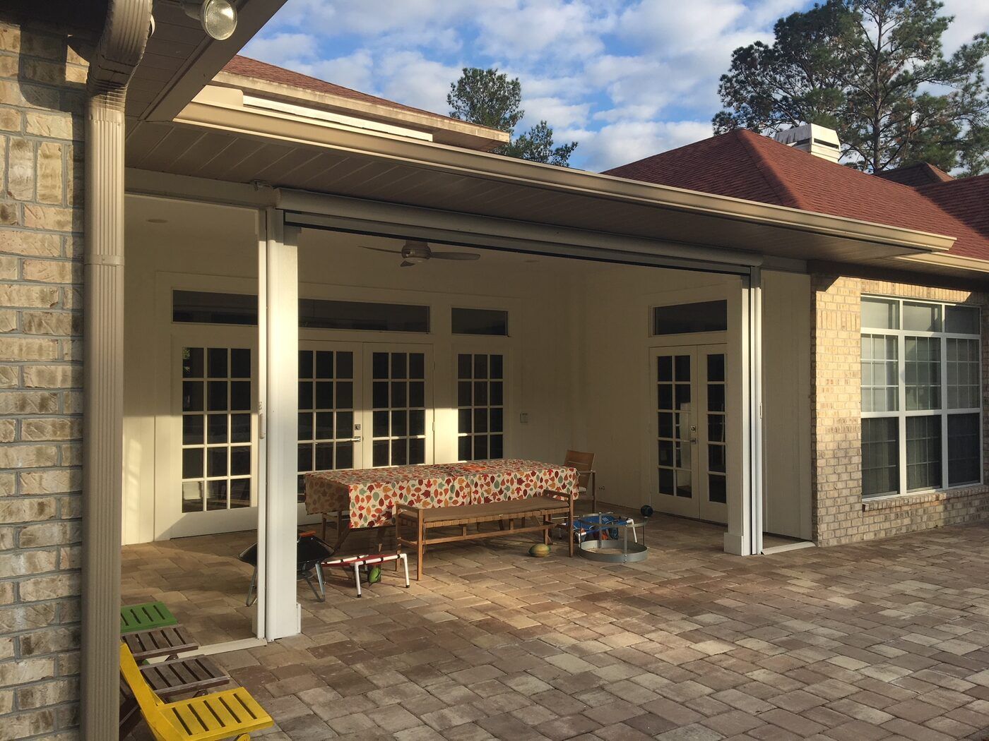 Motorized screens retracted on a covered patio