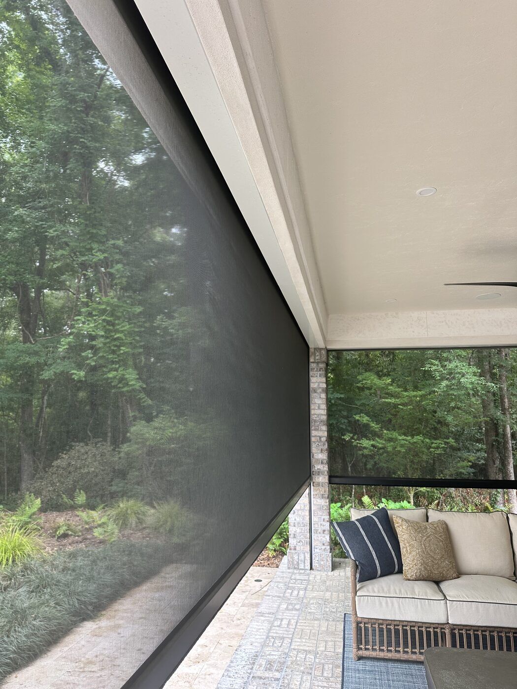 Motorized screen enclosure with a wooded view