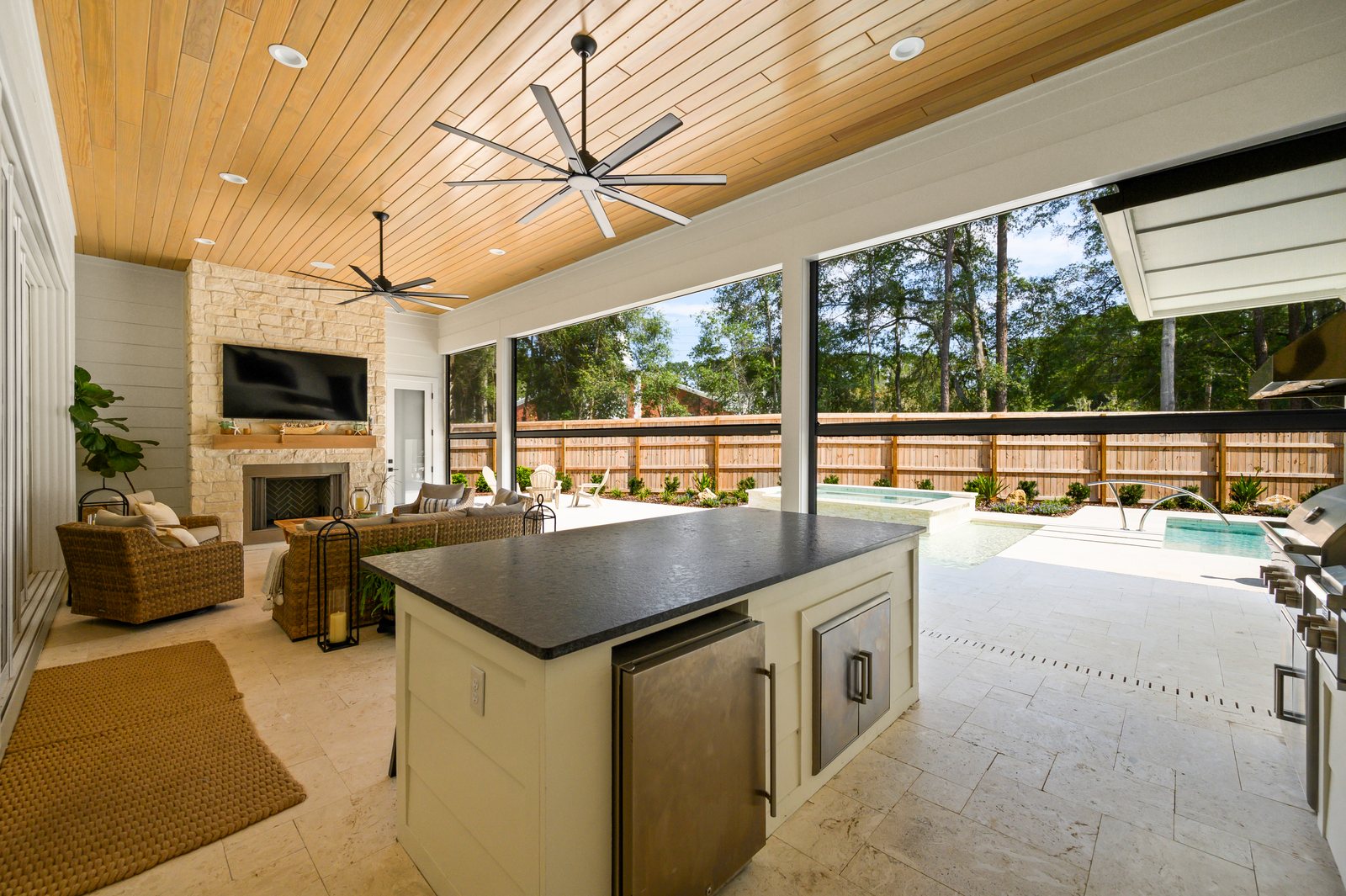 Outdoor living room under a wood ceiling with motorized solar screens