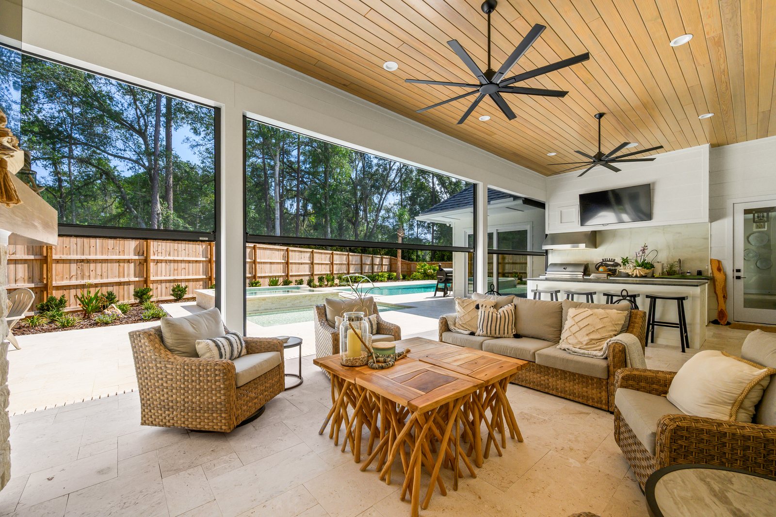 Poolside lanai with motorized solar screens lowered for shade