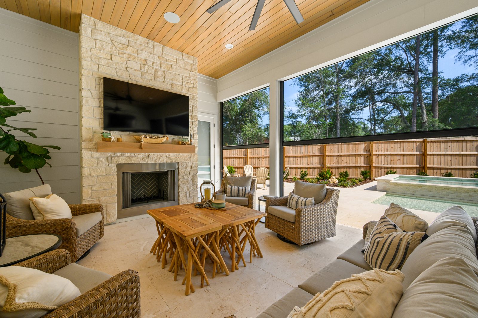 Covered outdoor kitchen and living space with motorized solar screens