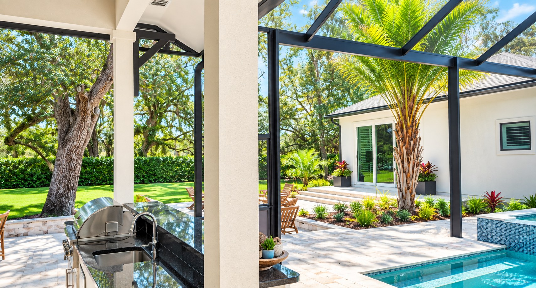 Motorized screen enclosure over a poolside patio with outdoor kitchen
